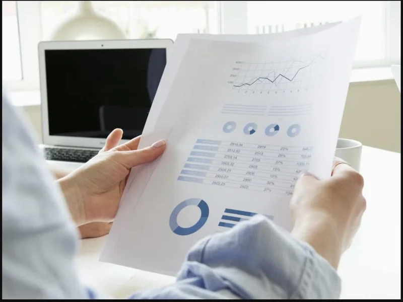 Business owner reviewing an operations report full of charts