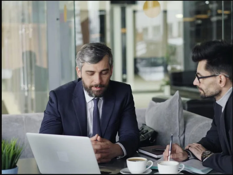 Two business advisors reviewing an AI roadmap on a laptop