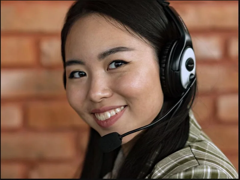 A friendly agent on a headset answering a customer call