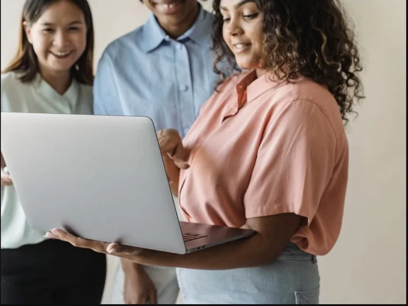 A team learning to use new AI tools together on a laptop